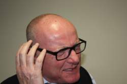 Man in discomfort due to Hearing Aid.