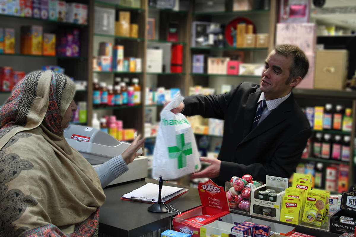 Pharmacist serving customer