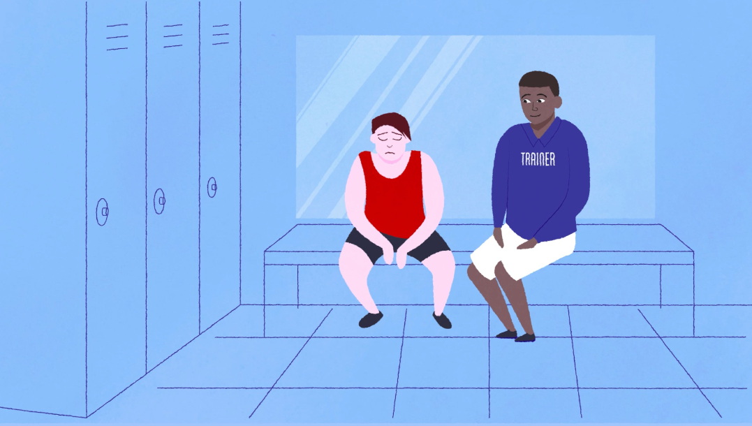 A still from video clip: Trainer talking to athlete in changing room.