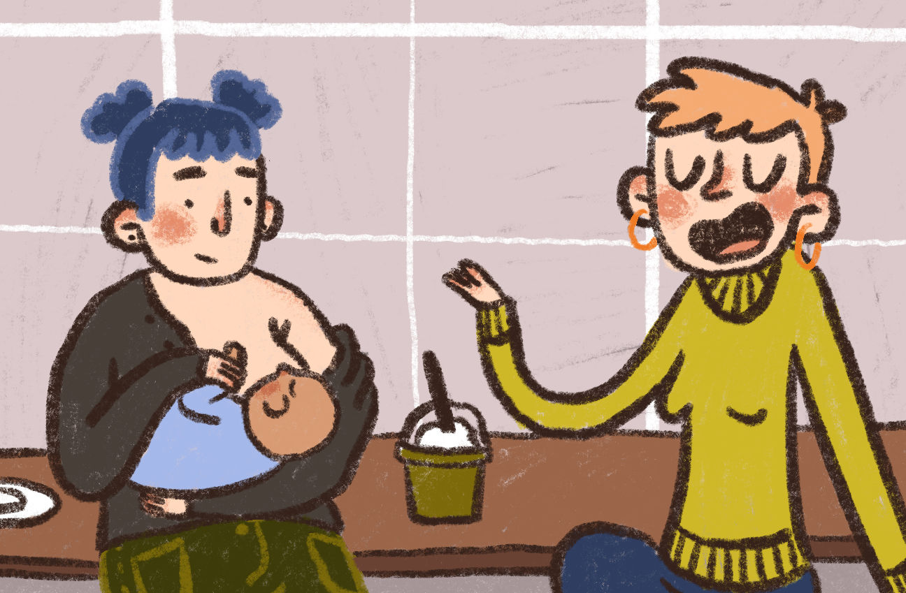 Feeding: Mother breastfeeding her baby in a cafe