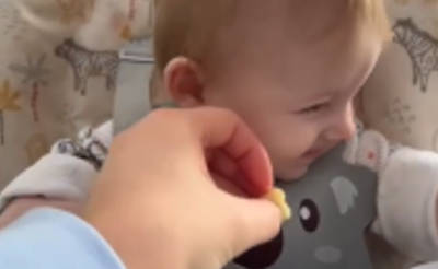 Baby turning their head away from food