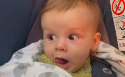 Baby sticking their tongue out