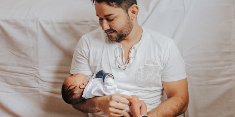 picture of Ben with his partner and their 3 week old baby