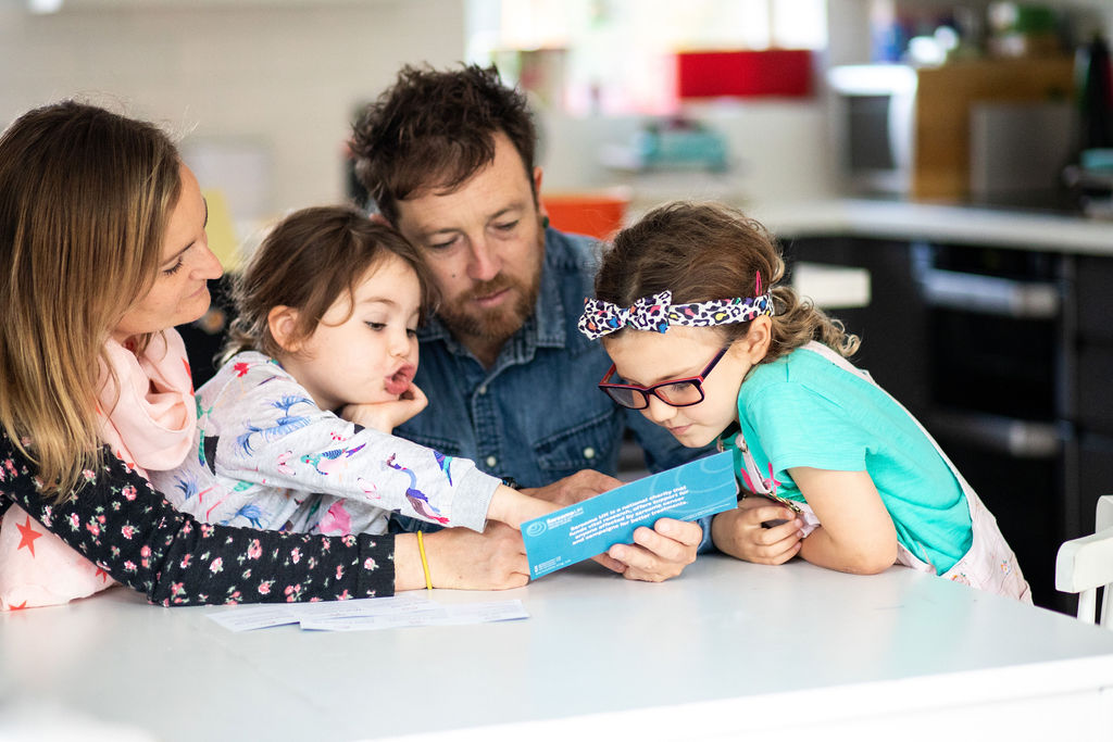 A family viewing a leaflet of information about sarcoma risks