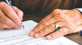 Image of someone signing a legal document.