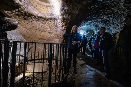 A tour guide talking in the caves at The City of Caves visitor attraction