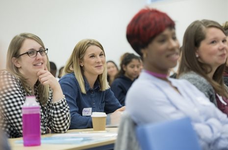 Row of students in a seminar laughing