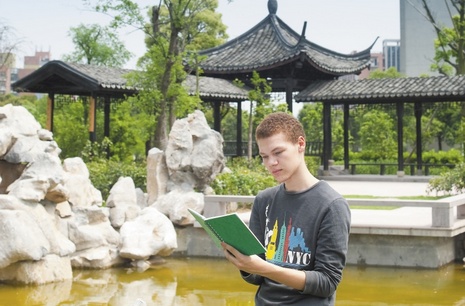 Student reading in front of a pagoda