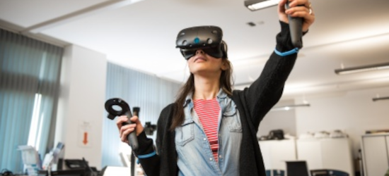 Woman wearing VR headset and holding two controllers