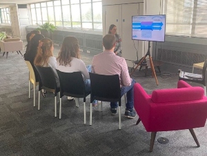 Four students listening to a presentation by an employer at Medicity