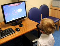 Child with 'lazy eye' looking at computer screen