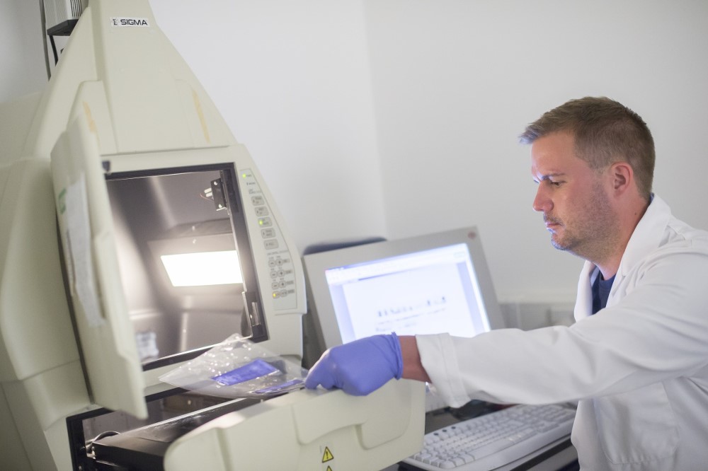 Academic analysing the results of a test in a medical lab