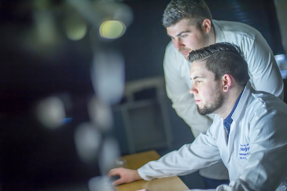 A person typing on a laptop