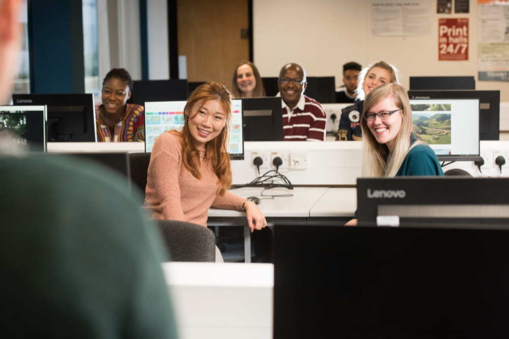 Students listening to training session in a computer room