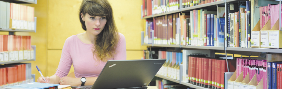 Student using a laptop in the library