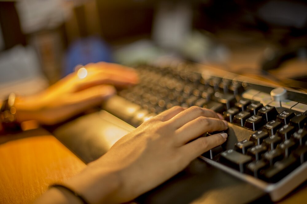 Image of hands typing on keyboard