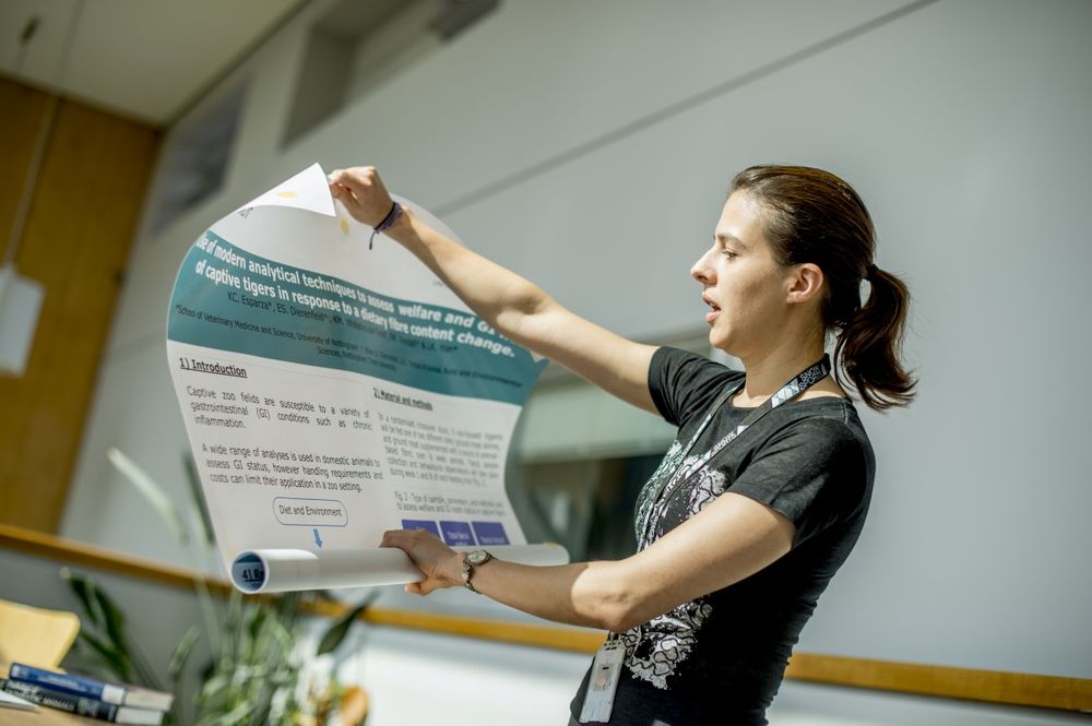 Researcher explaining a poster