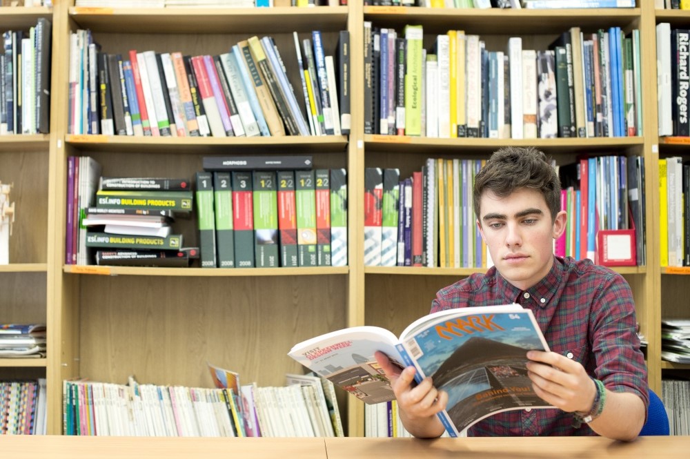 Student reading in a library