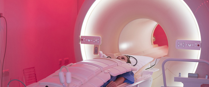 Person being wheeled into the hole inside a large MRI machine