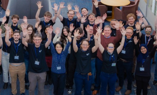 A group of people with their arms raised