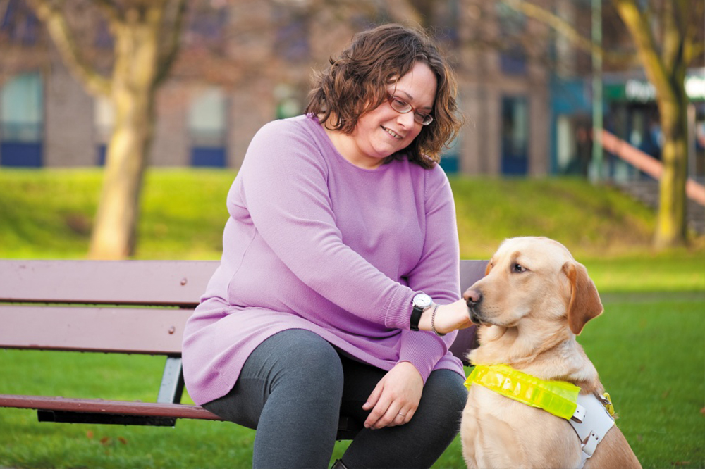 University Disability Advisor petting guide dog Tilly