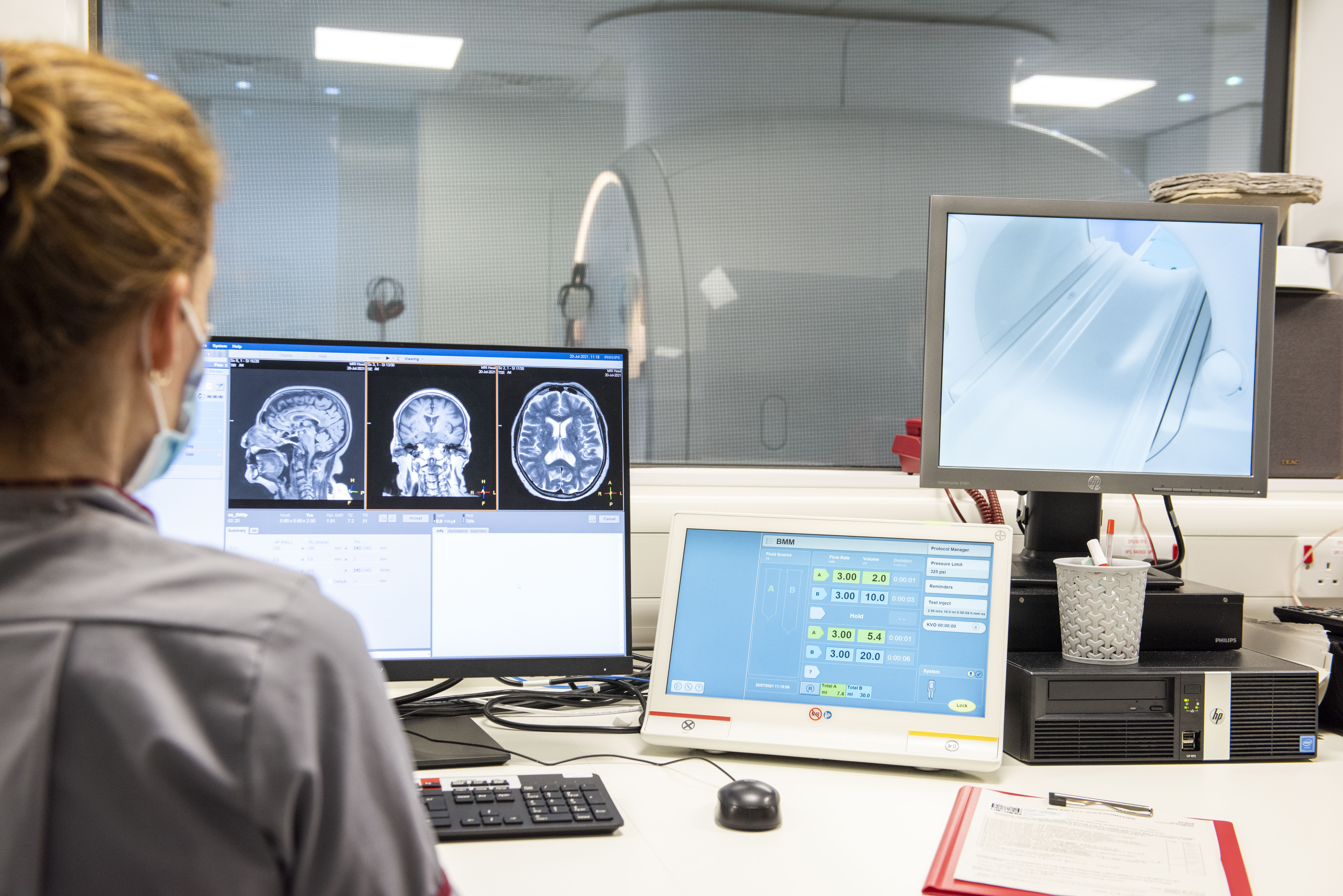 A researcher looks at brain scans