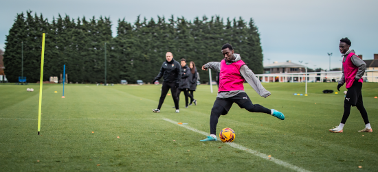 Academy players and staff on training pitch