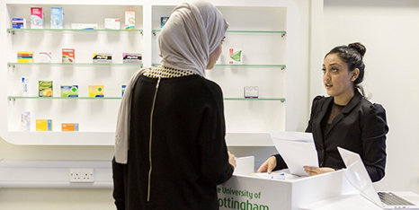 A pharmacist serving a customer at our pharmacy counter, University Park
