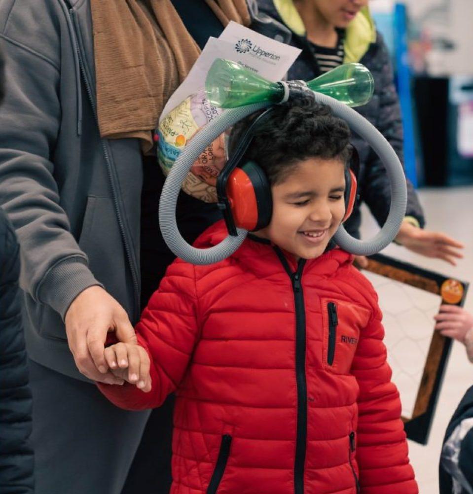 Child at the Festival of Science wearing a head piece