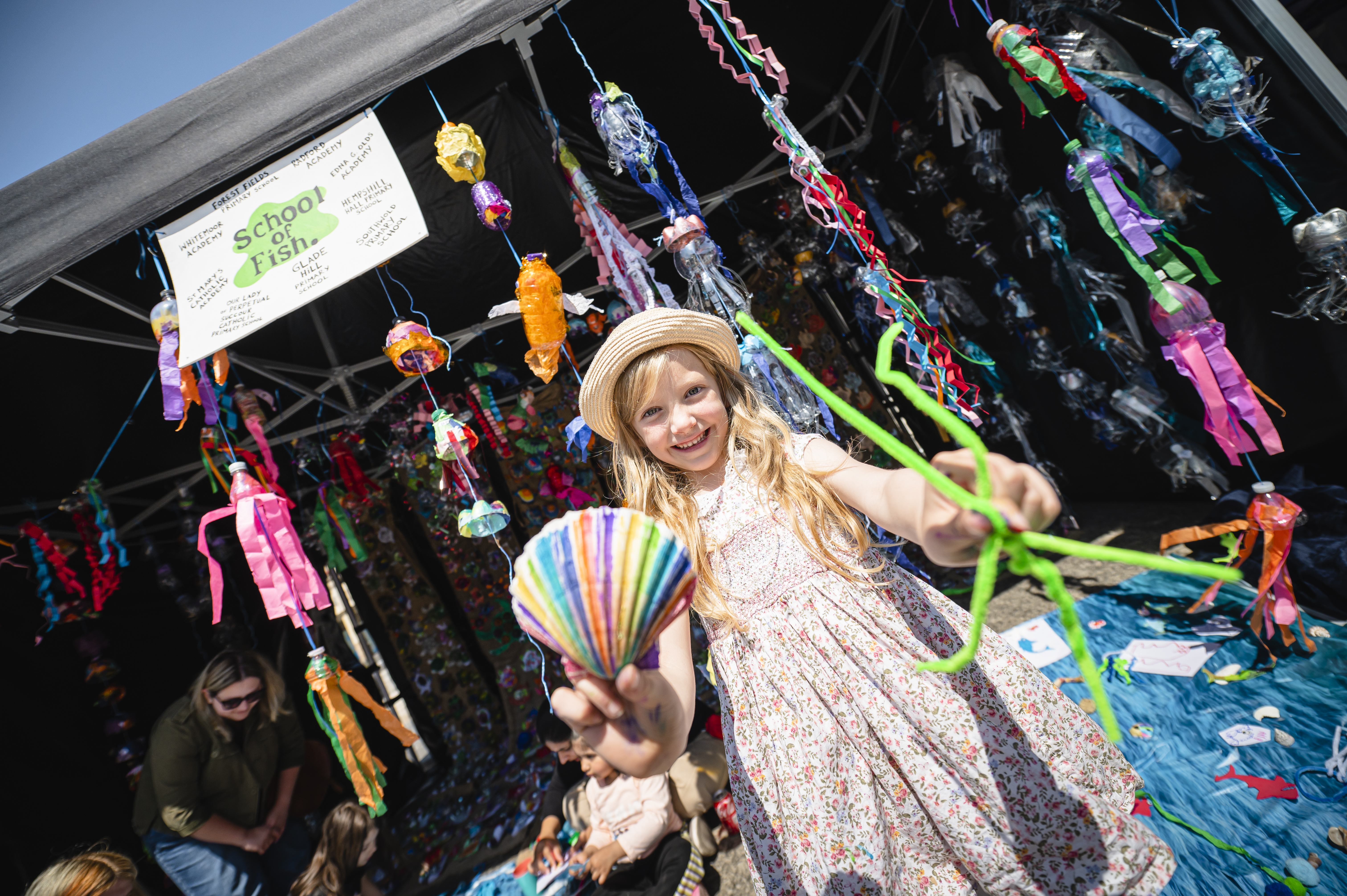 Image of child at Green Hustle surrounded by colourful streamers