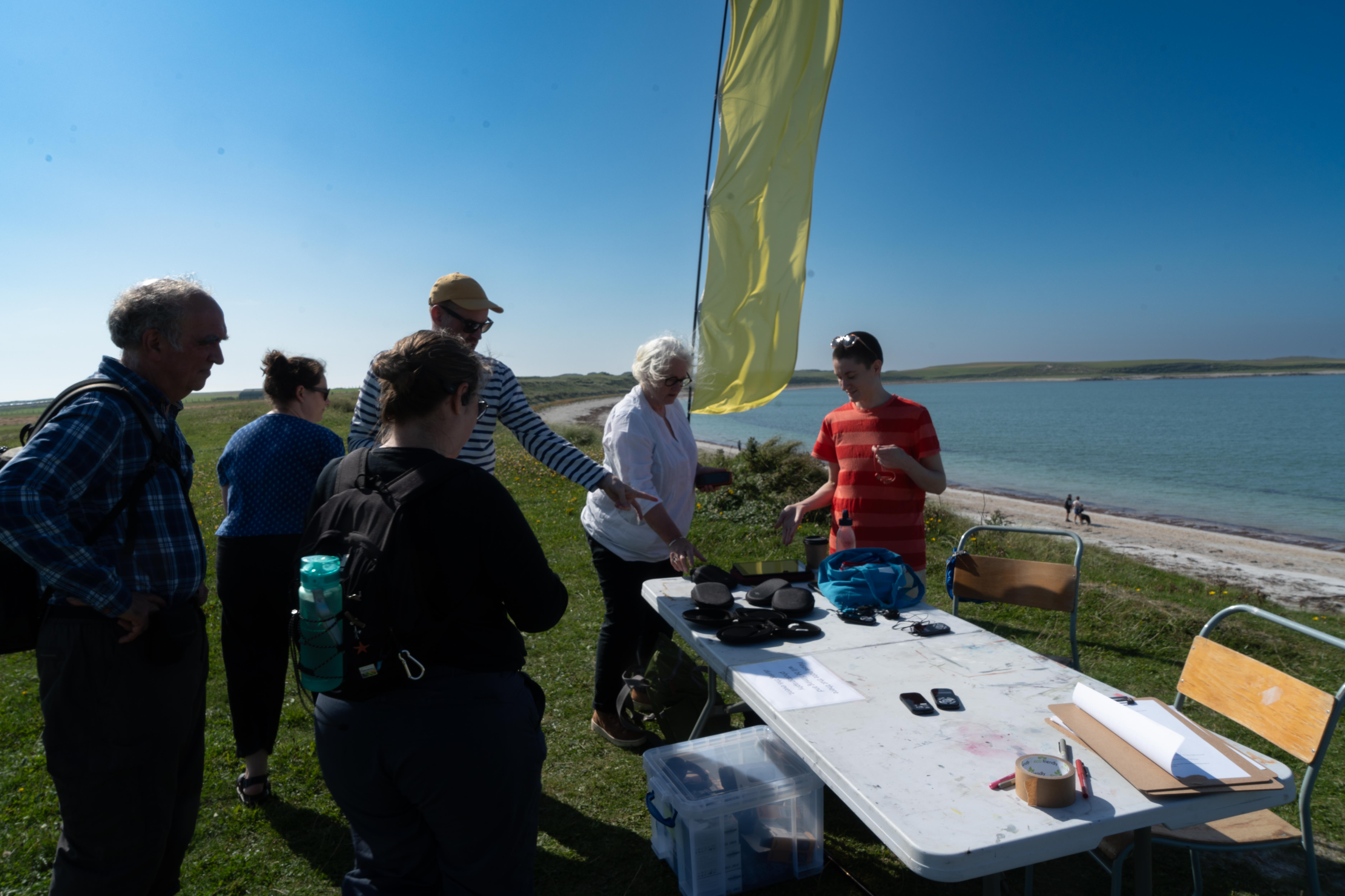 A group of people standing by the lake 