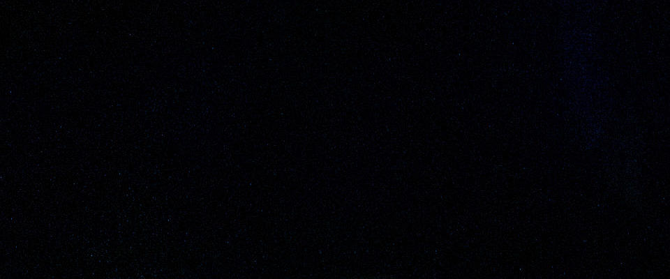 One man in a red shirt presenting on stage in front of an audience