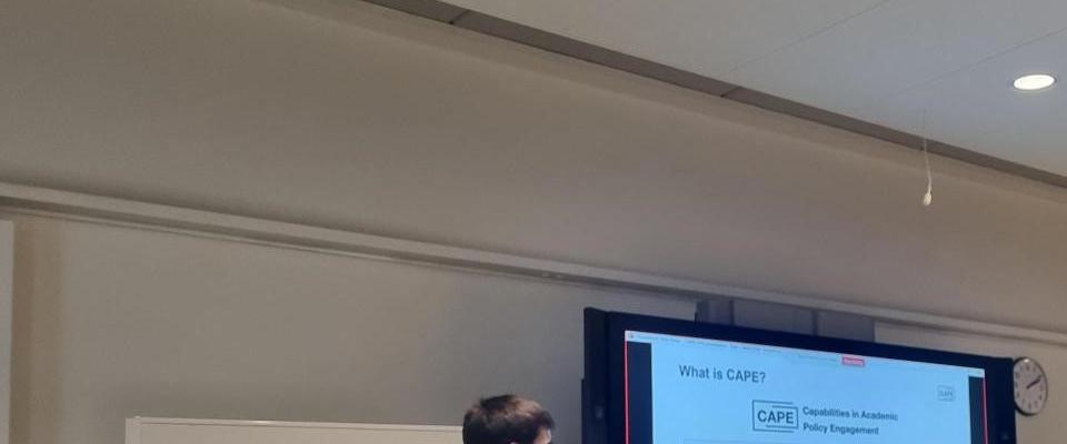 A man standing in front of a screen