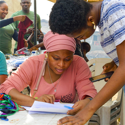 An adults woman giving medical assistance to another adult woman