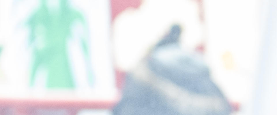 A woman in a dark blue t-shirt helping a small child with a craft