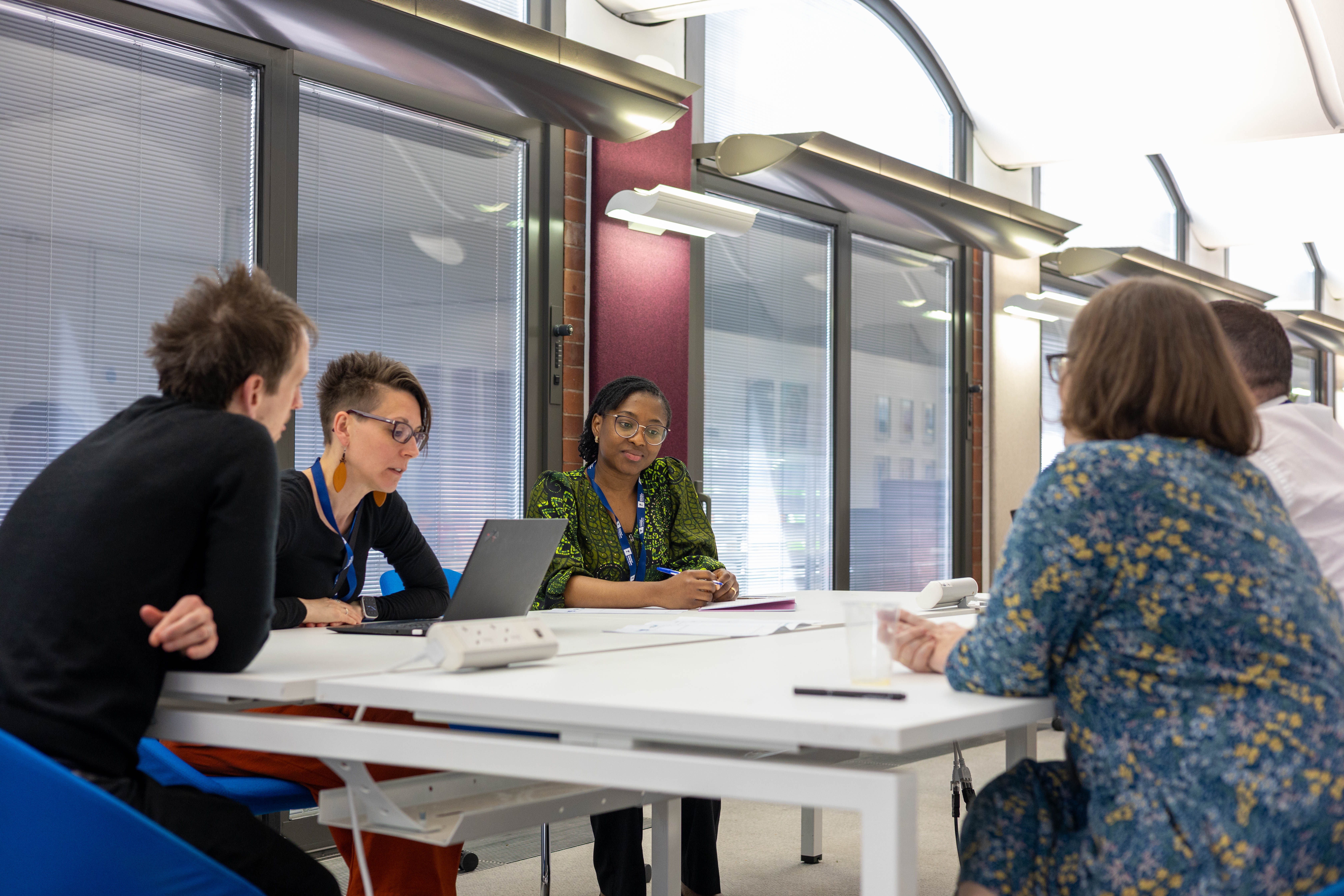 Group of people working together around a table