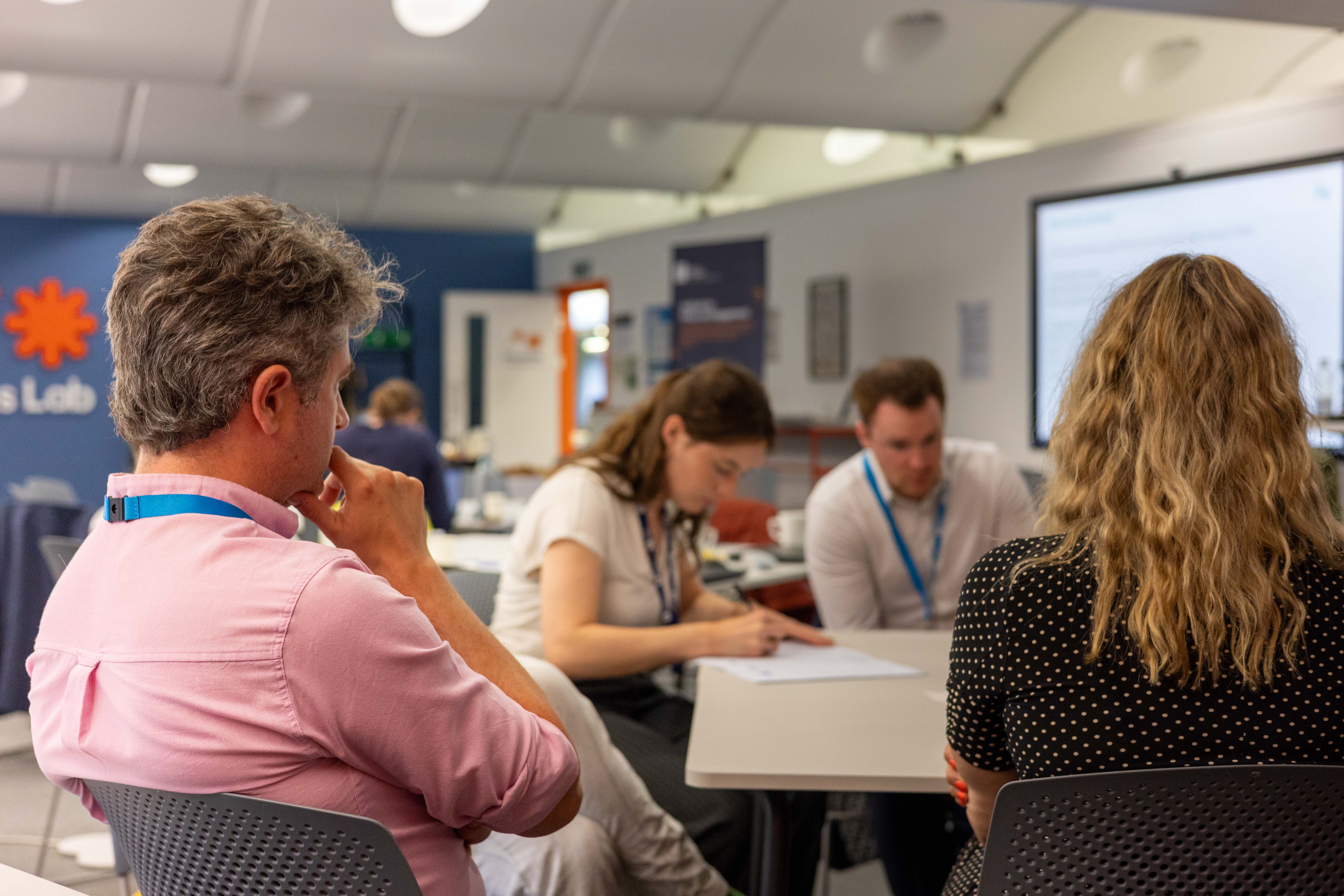 Group of people sat around a table talking