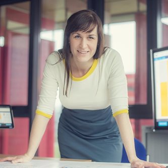 White woman smiling in an office