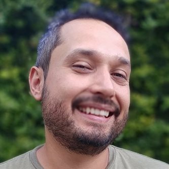 Headshot of a hispanic man in a t-shirt smiling