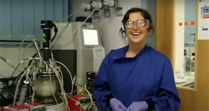 female scientist laughing in lab