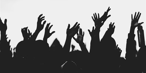Silhouettes of raised hands