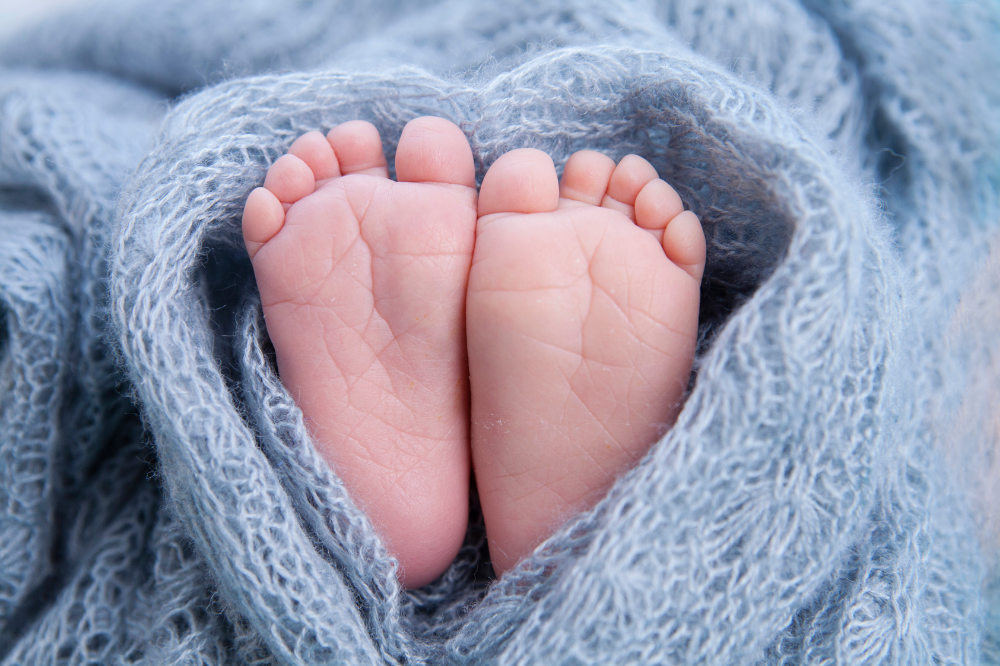 baby feet wrapped in blue blanket