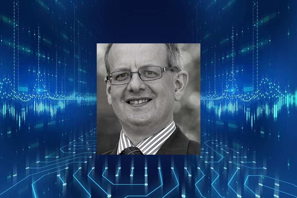 Johnathan Hirst, man with glasses with blue line patterned background