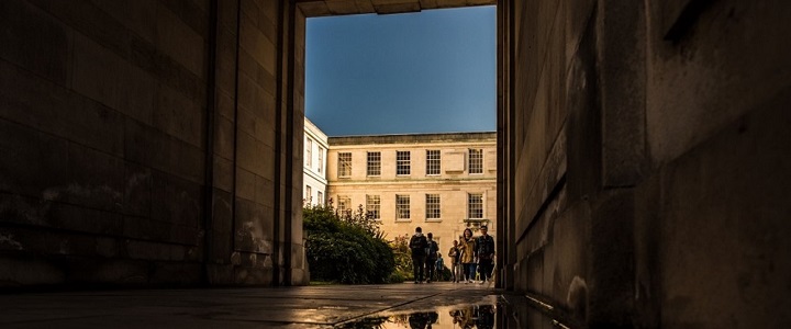 Photograph of Trent building in the evening sunlight through an archway