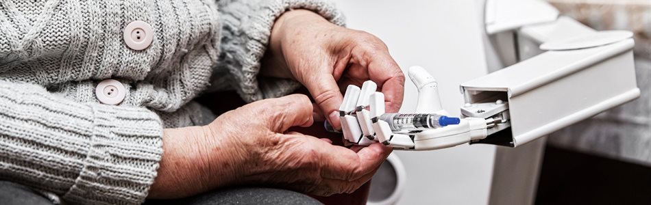 Elderly woman handing a syringe to a robot