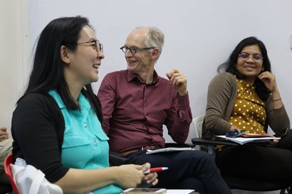 Researchers laughing during a meeting