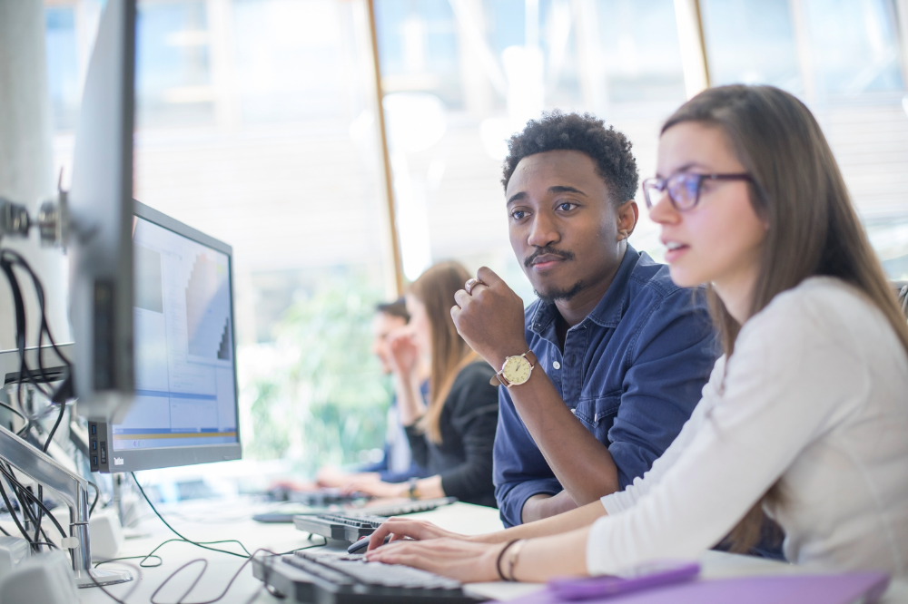 Undergraduate students using desktop computer