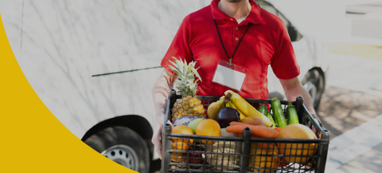 Close up of a male courier holding a box of food products