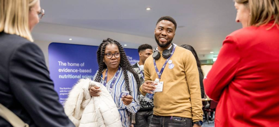 People chatting at an information stand