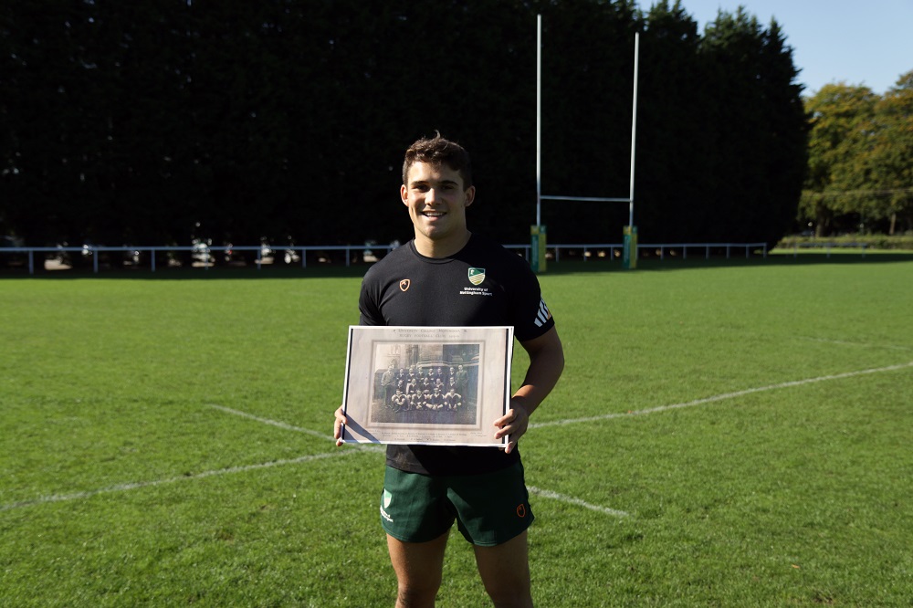 Men's First XV captain Alfie Orchard with an archive photo of the first ever men's team in 1919